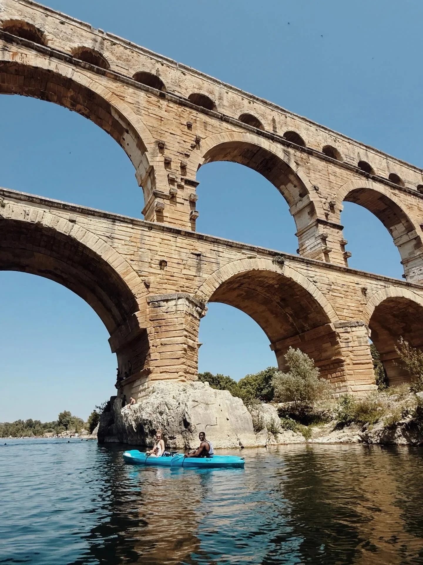 The Pont du Gard, the Roman aqueduct near Maison de Frederic, with kayakers on the river below